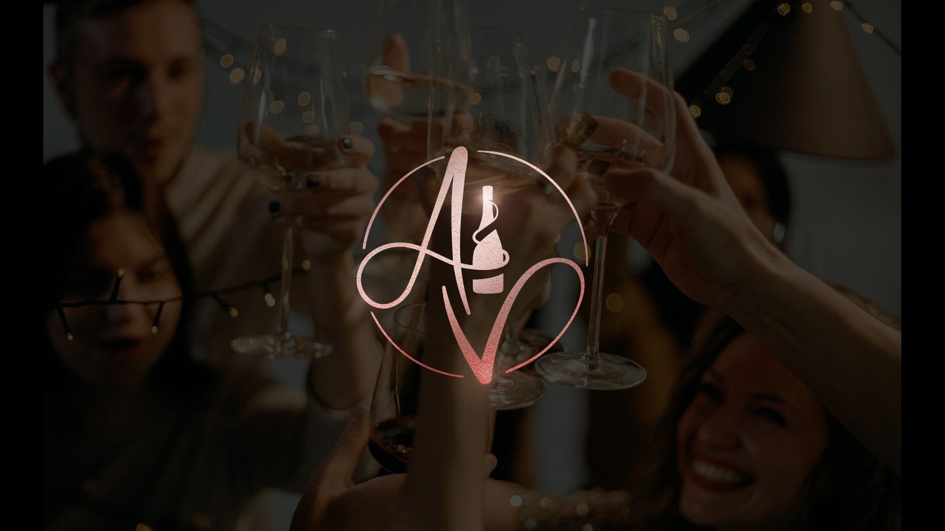 The rose-copper foil monogram glowing over a dim photograph of friends raising glasses under string lights.