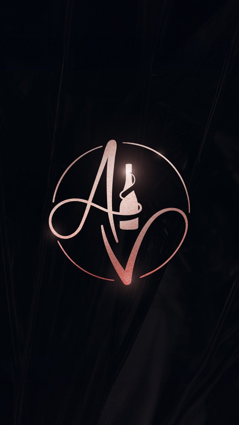 Story format: the foil monogram on a dark draped background, a highlight on the bottle.