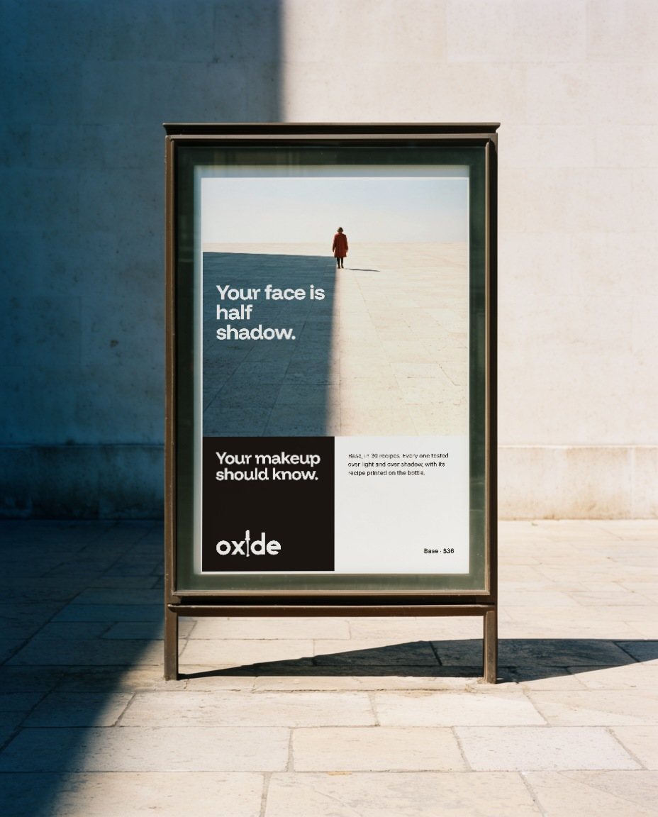 A six-sheet poster in a street case, in hard sun: Your face is half shadow. Your makeup should know.