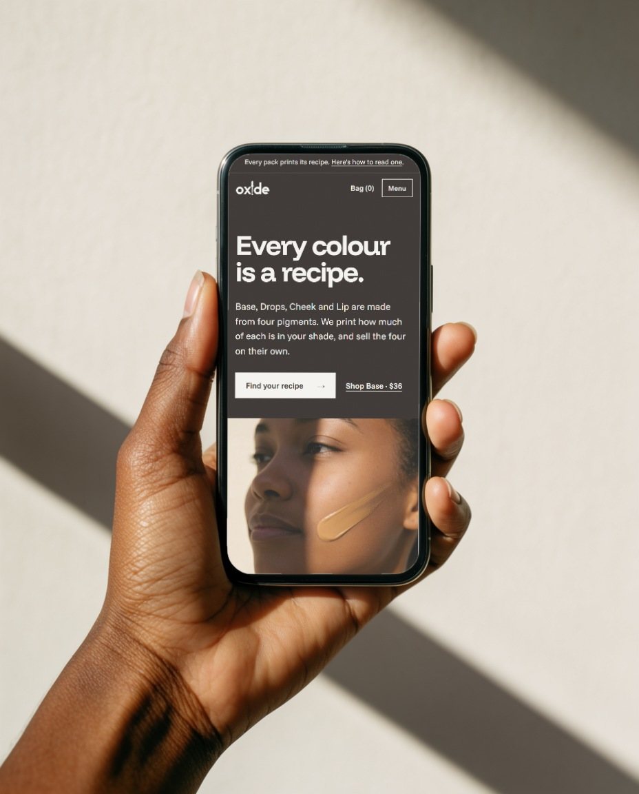 The Oxide homepage on a phone in hard sun