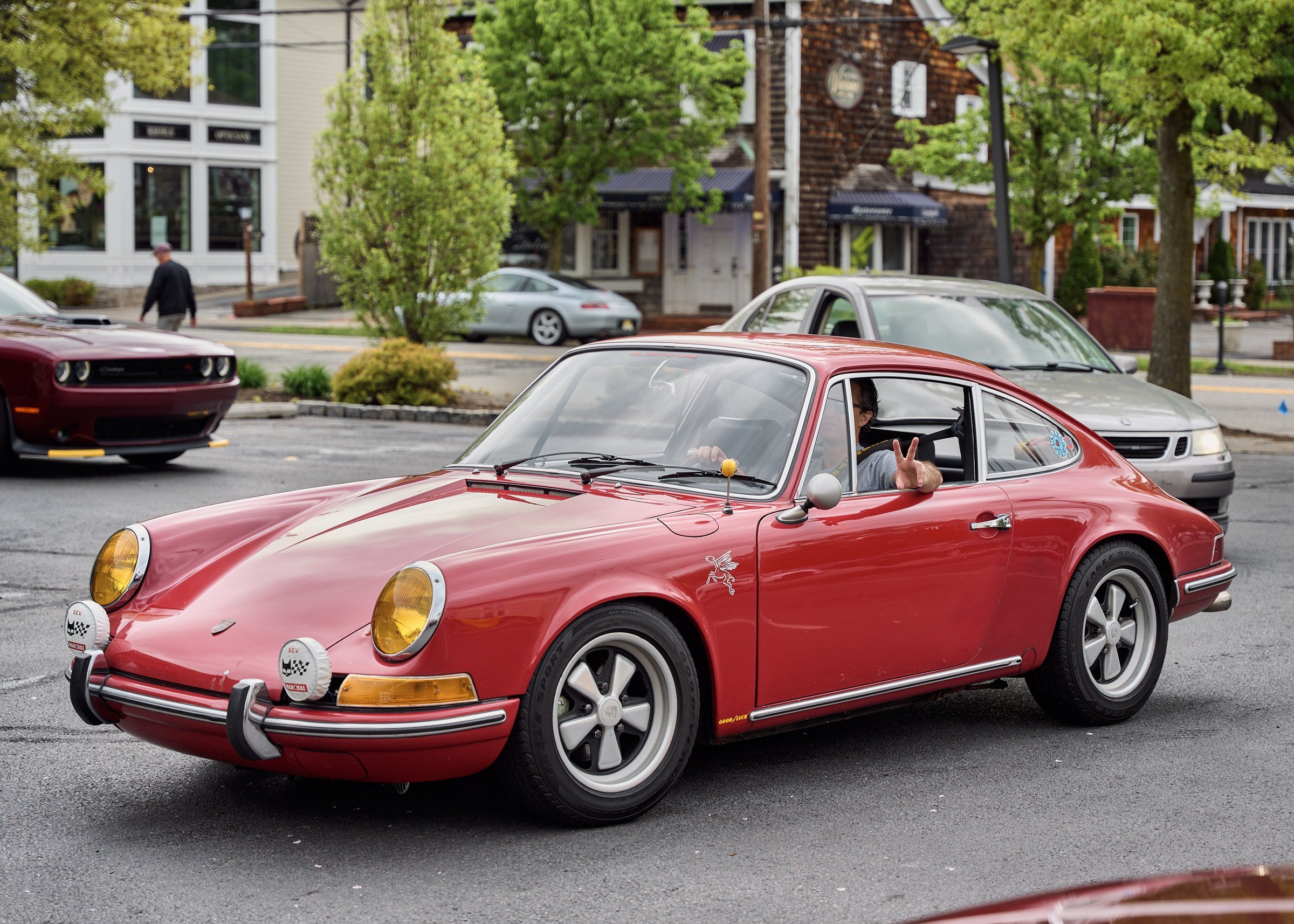 A red classic Porsche 911 in the rally car park.