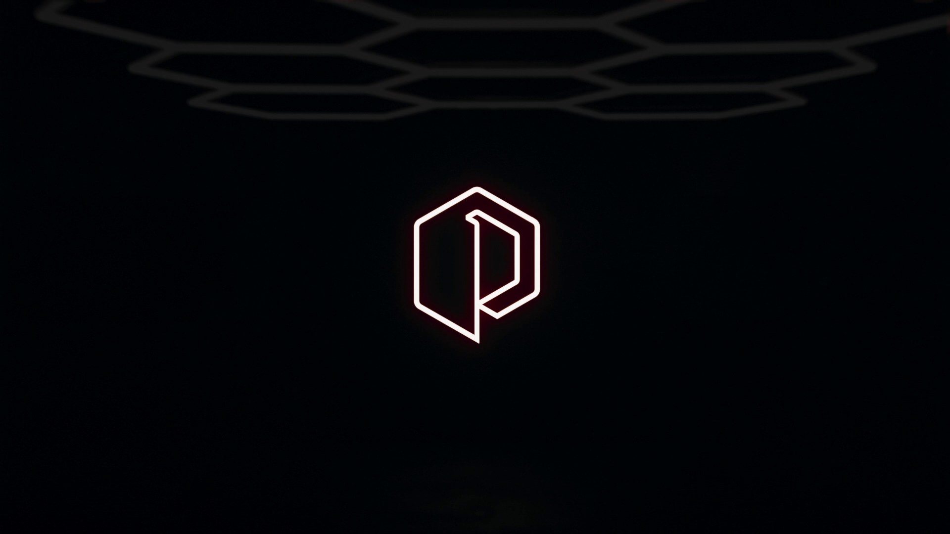A frame from the teaser: the mark in neon outline under a dark hexagonal ceiling.