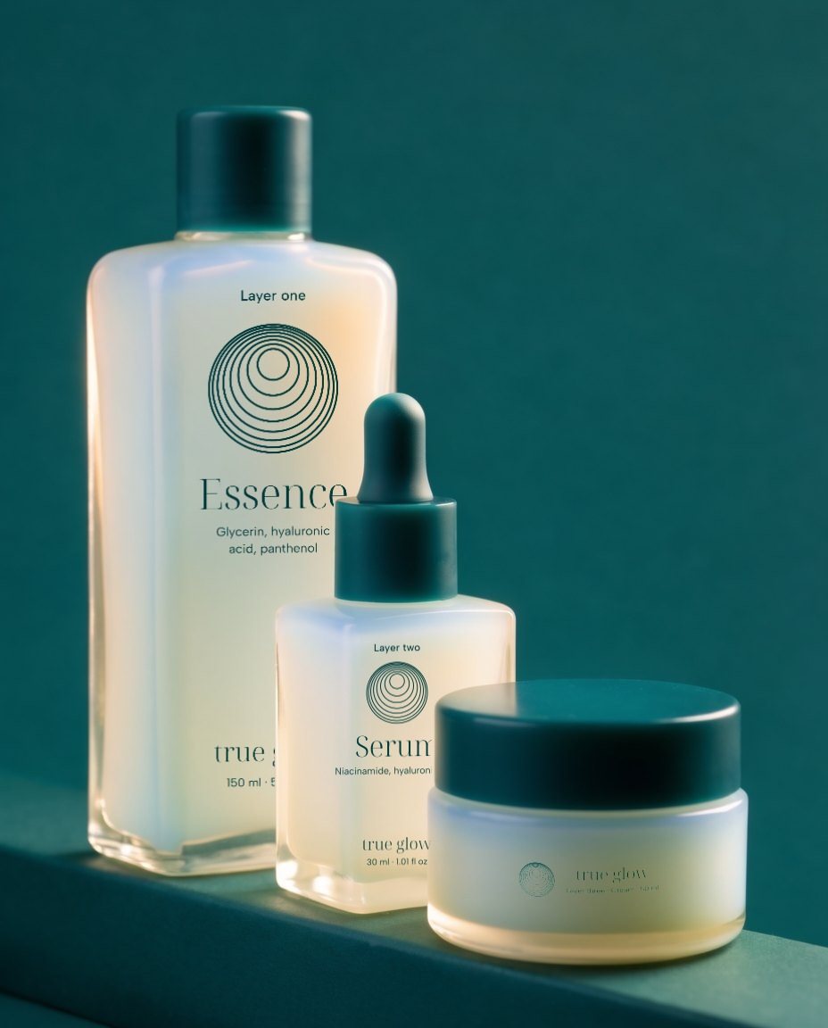 The Essence, the Serum and the Cream in opal glass, standing in depth